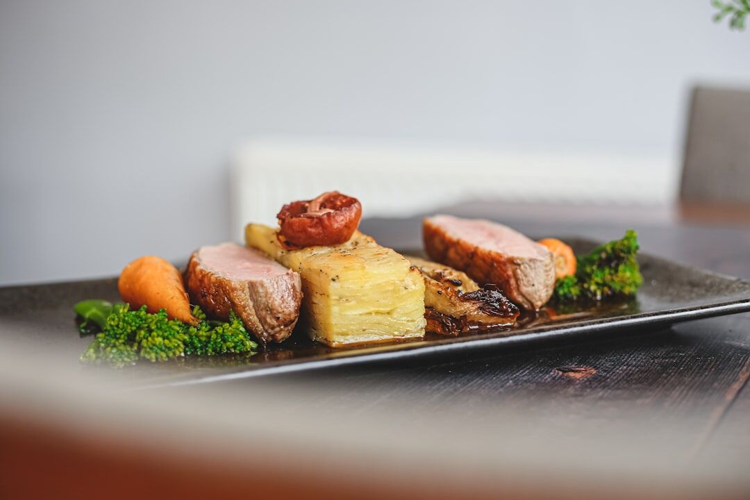 Traditional Czech beef sirloin sauce with bread dumplings served on a wooden table