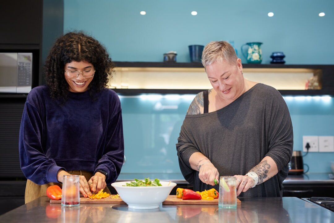 Small editorial team preparing recipes together in a kitchen