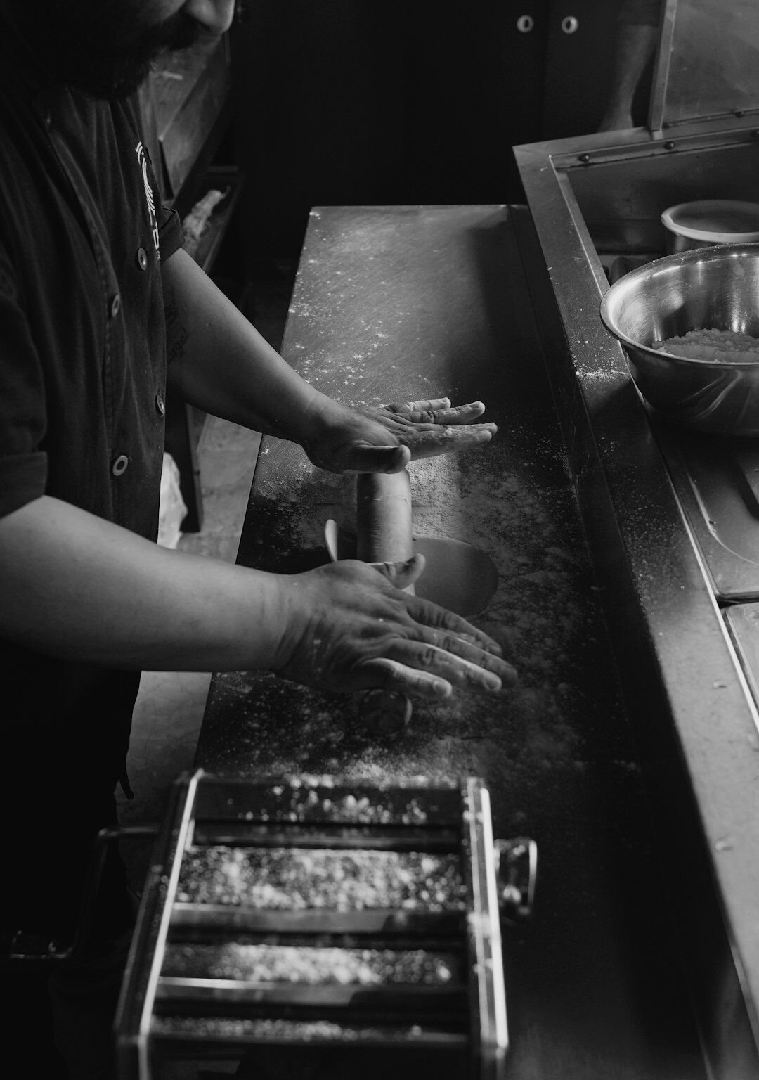 rolling out pasta dough with machine